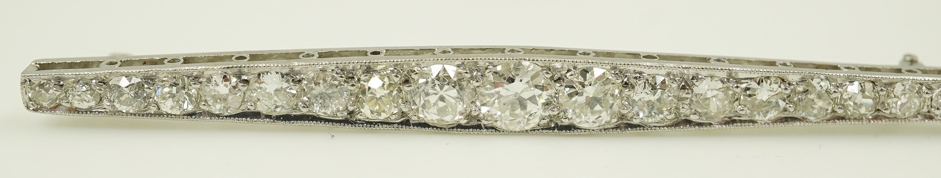 A 1920's platinum? and nineteen millegrain set graduated diamond bar brooch